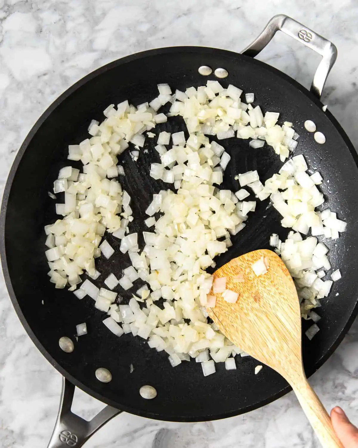 Sauteing onion and garlic in a pan with salt.  