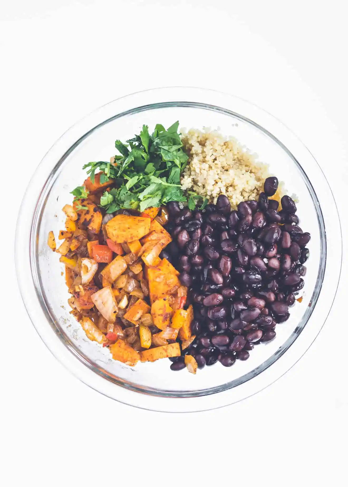 Bowl of cooked sweet potatoes, cilantro, quinoa and black beans