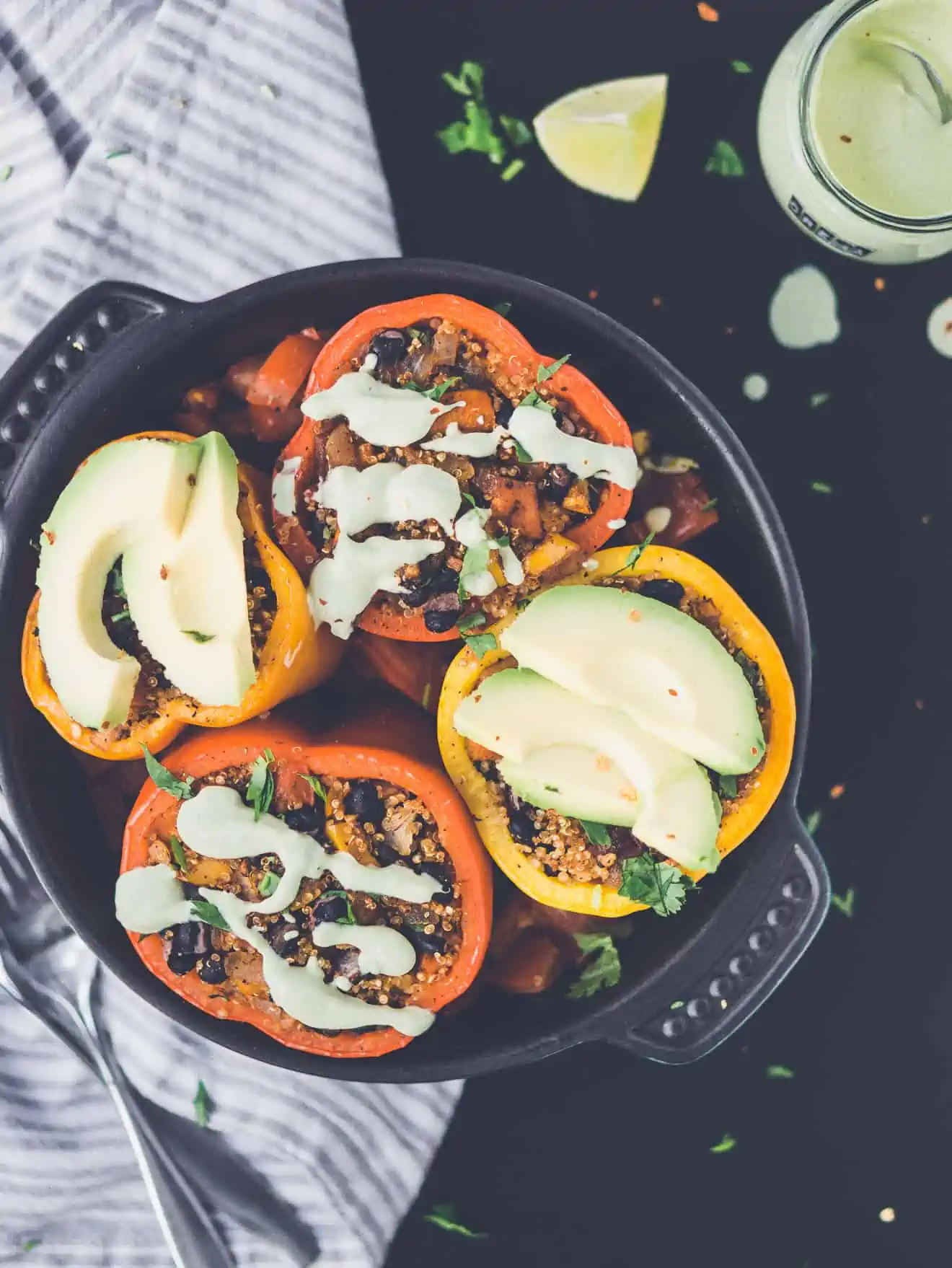 Chipotle Stuffed Peppers with avocado and sauce on top