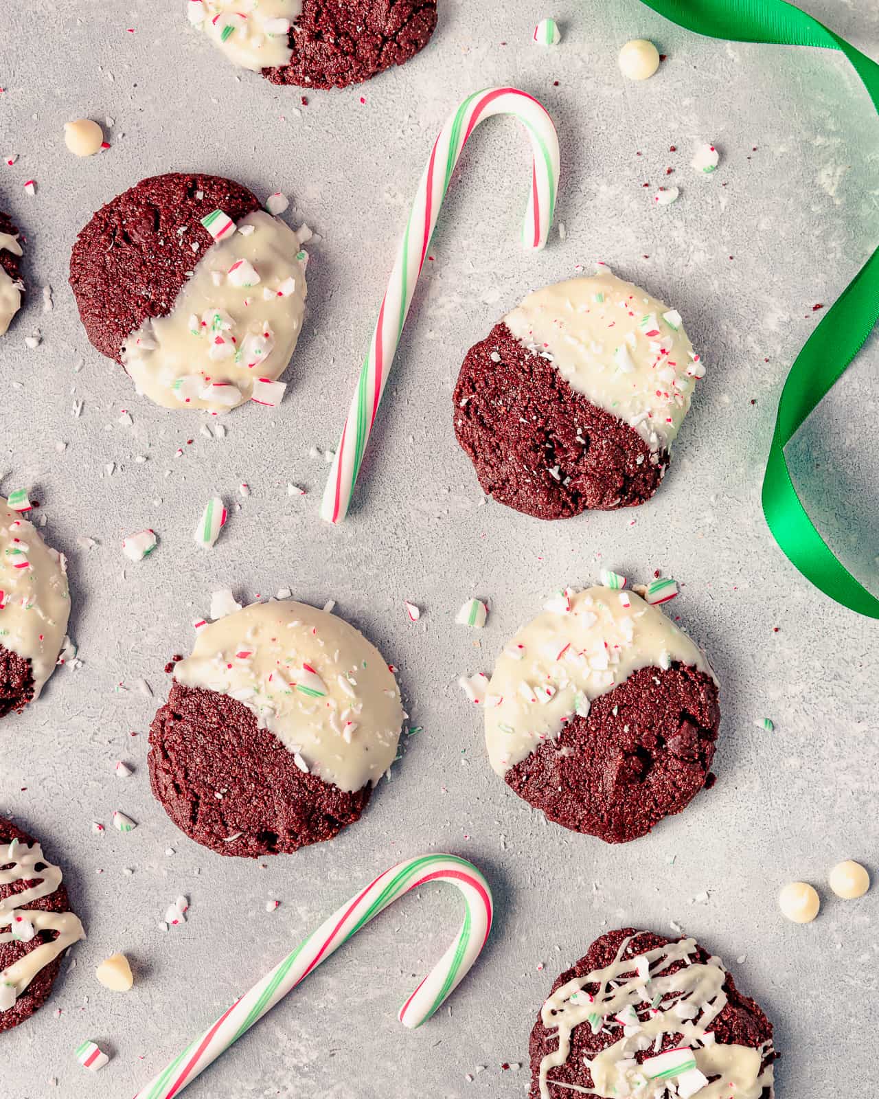 Holiday chocolate cookies drizzled with white chocolate and topped with candy cane.