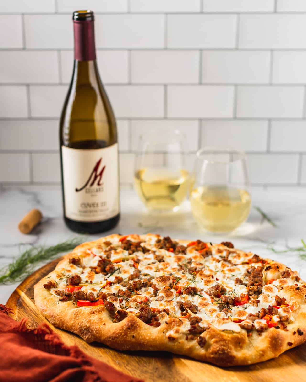 homemade fennel and sausage pizza paired with a white wine