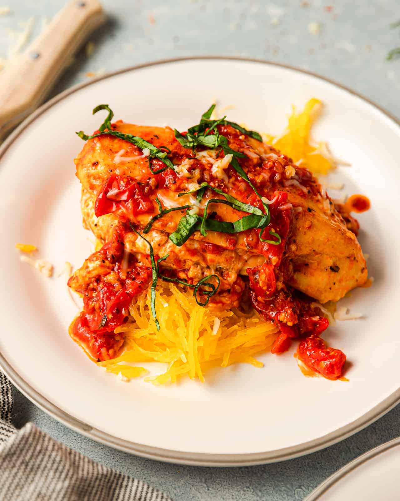 Pizza Stuffed Chicken Breast served with Spaghetti Squash and topped with fresh basil