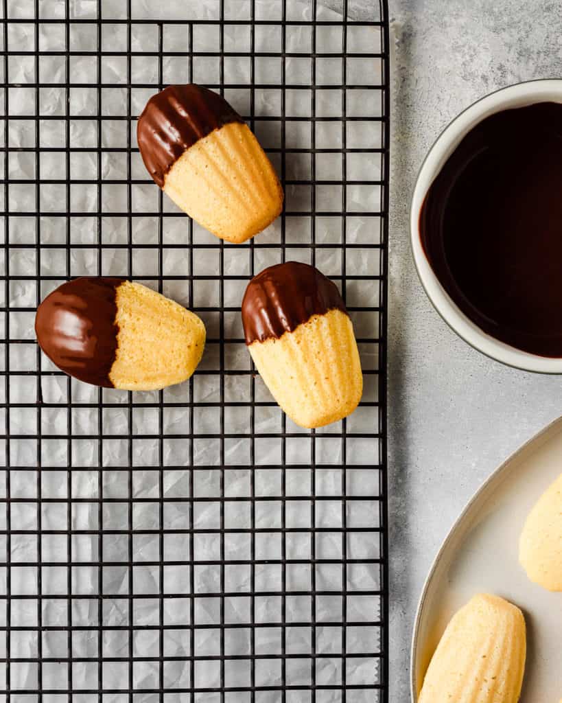 dipping madeleines into chocolate
