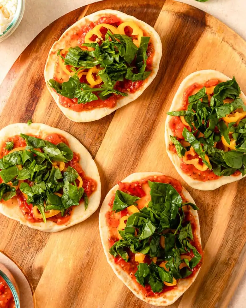 Naan Pizza with marinara, sweet peppers and spinach on top.