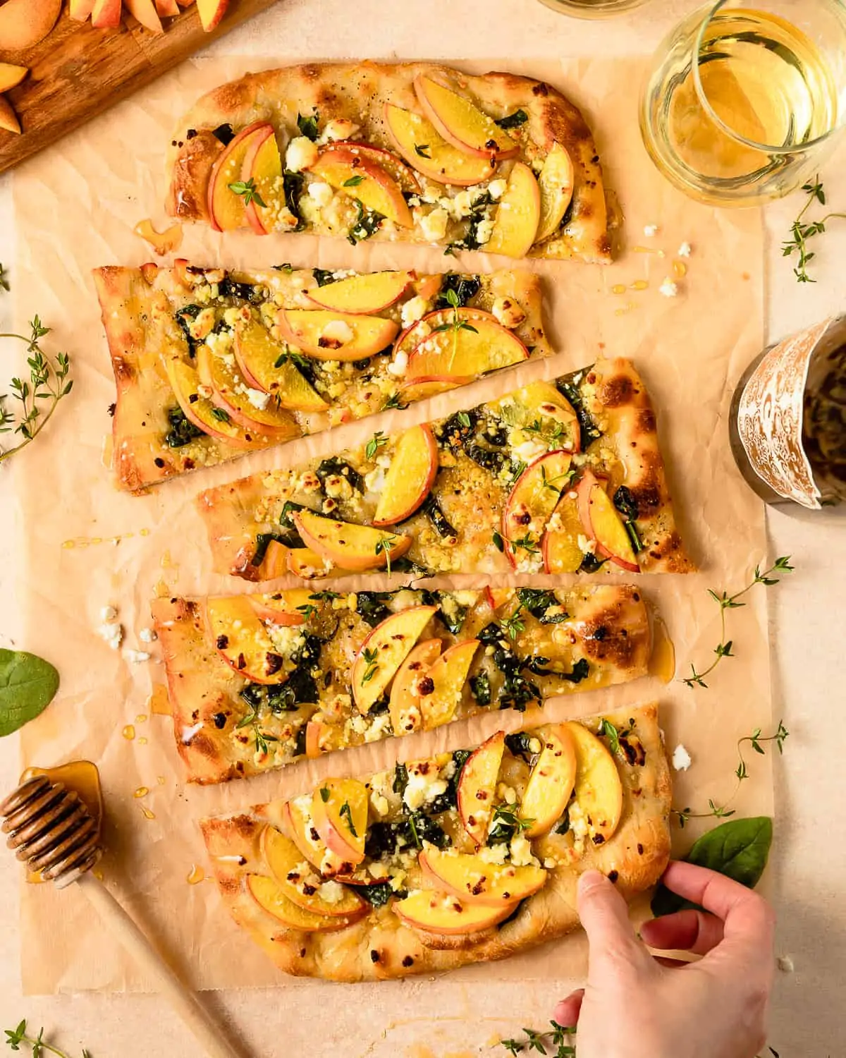sliced Pizza with Goat Cheese, peaches, and spinach. 