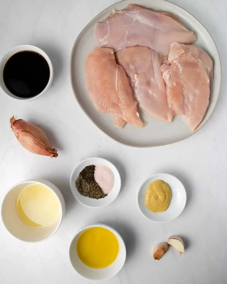 ingredients for balsamic glazed chicken: garlic, shallot, chicken breast, balsamic vinegar, olive oil, lemon juice, dijon mustard, and spices. 