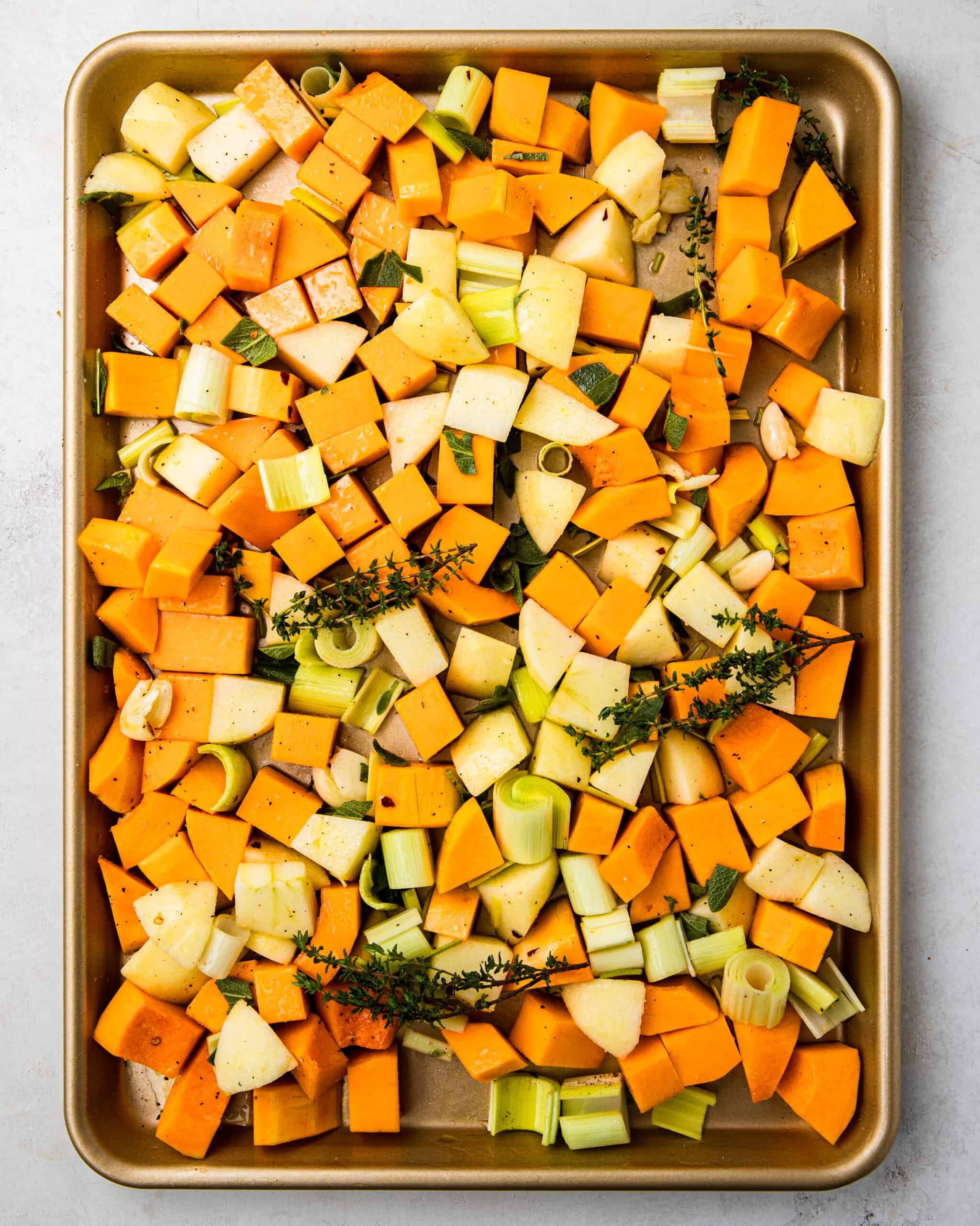 veggies on a pan with olive oil and spices.