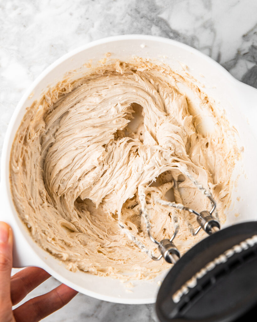 whipping cinnamon frosting.