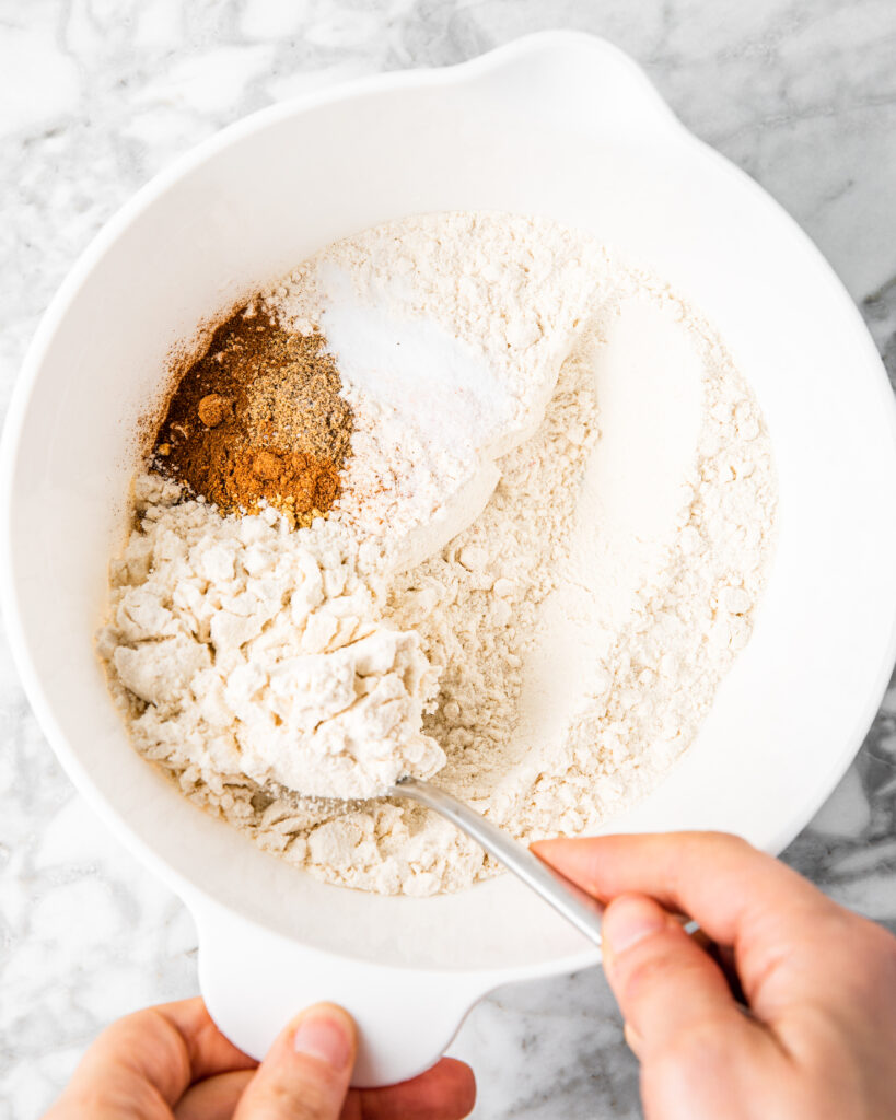 tossing dry ingredients together in a bowl.