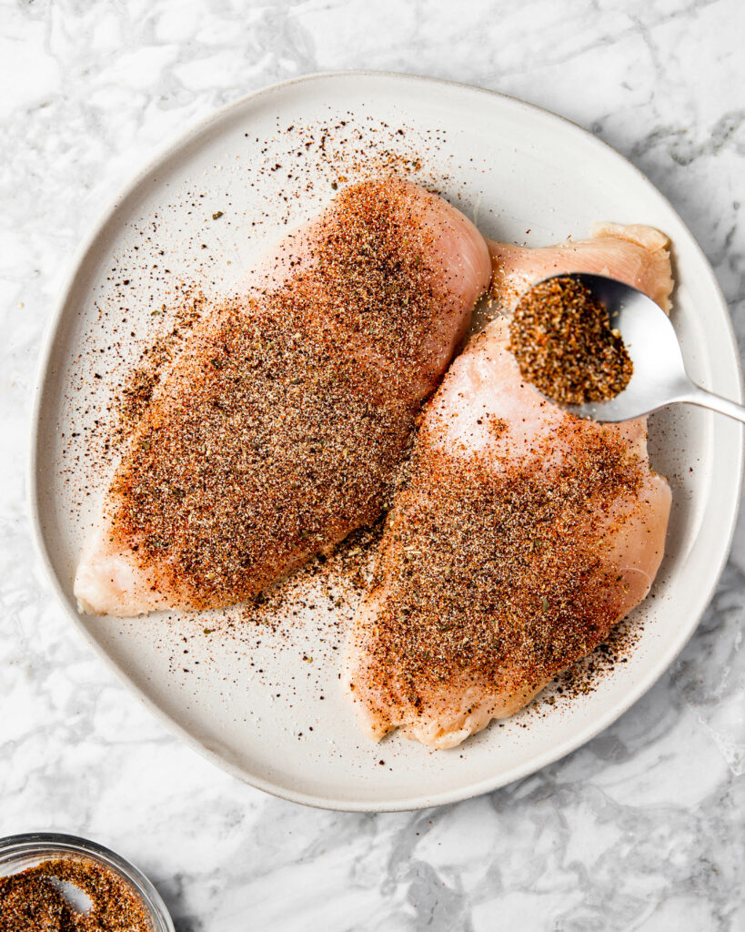 seasoning chicken breast with ancho chile.
