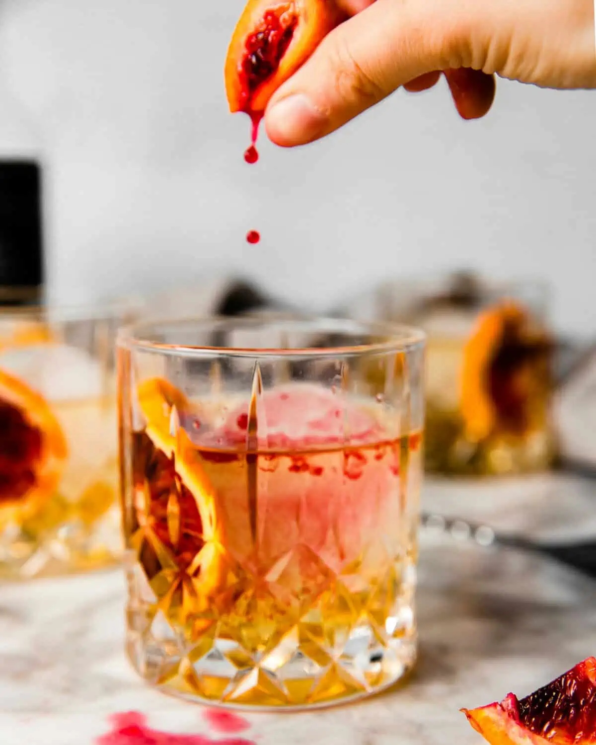 a tequila old fashioned with a squirt of blood orange juice.