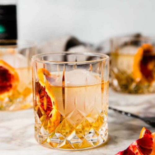 whisky glasses with anejo tequila and blood orange.