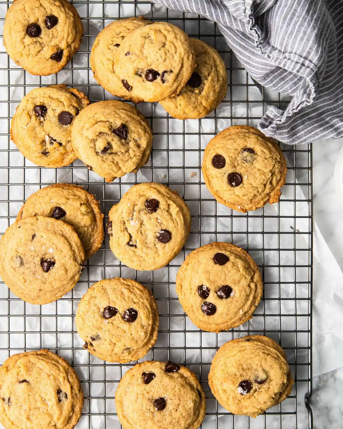 bakery style chocolate chip cookies on a cooling rack.