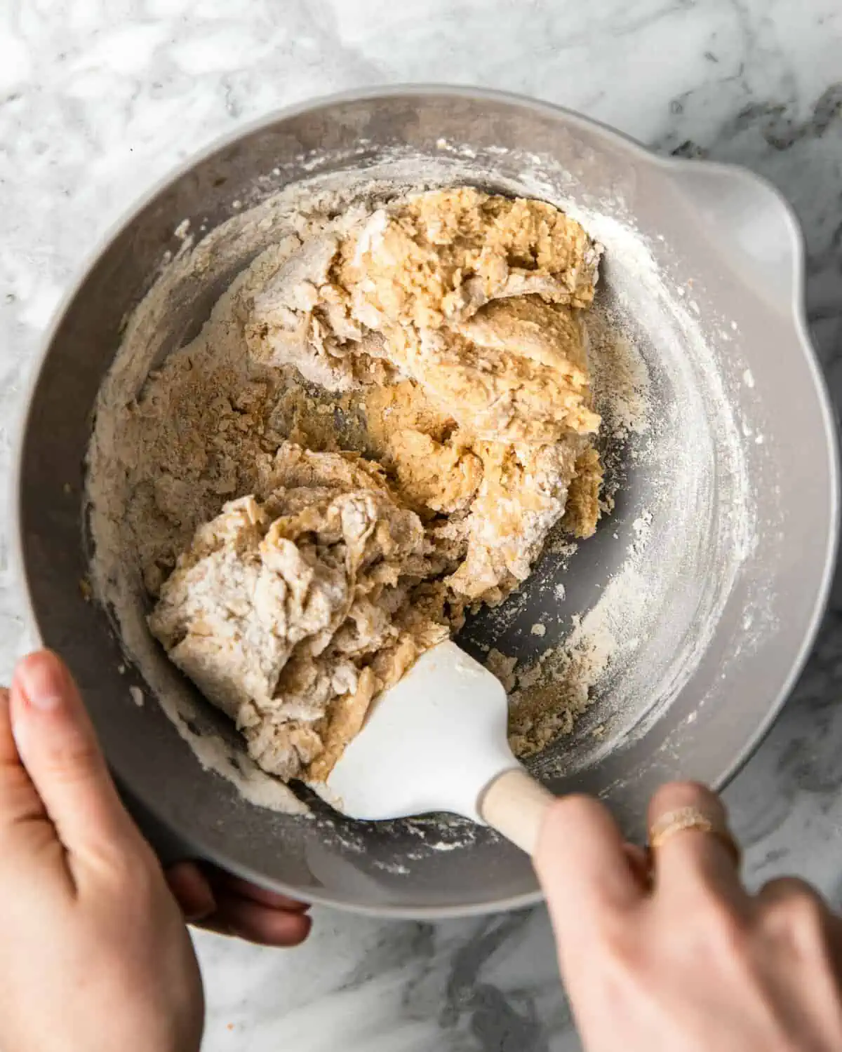 folding dry into the wet ingredients in a bowl with a spatula. 